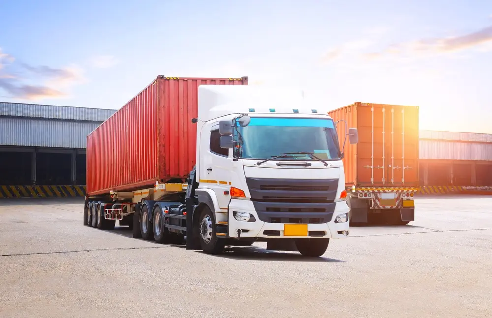 Semi-trailer trucks at a logistics warehouse