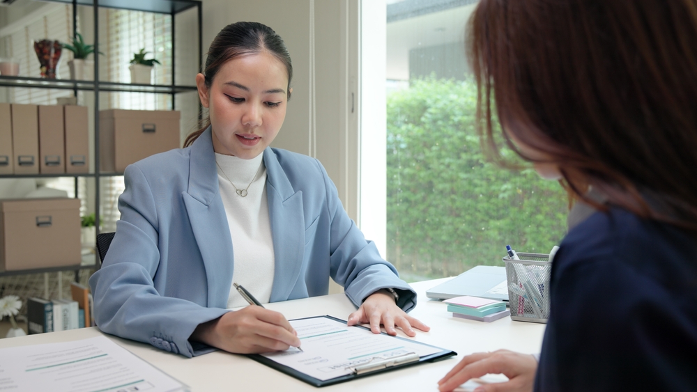 An asian supplier helping check a Thai food manufacturing quality inspection checklist