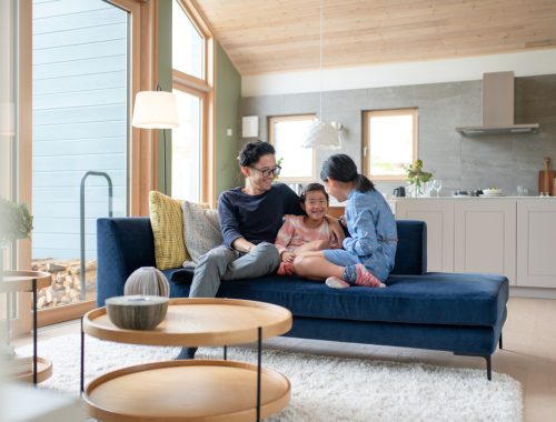 Father relaxing with his daughters on the sofa. Okayama, Japan. 2021
